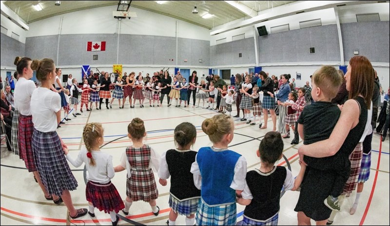 Auld Lang Syne is sung while hands are crossed in a big circle to end the dance portion of the evening.