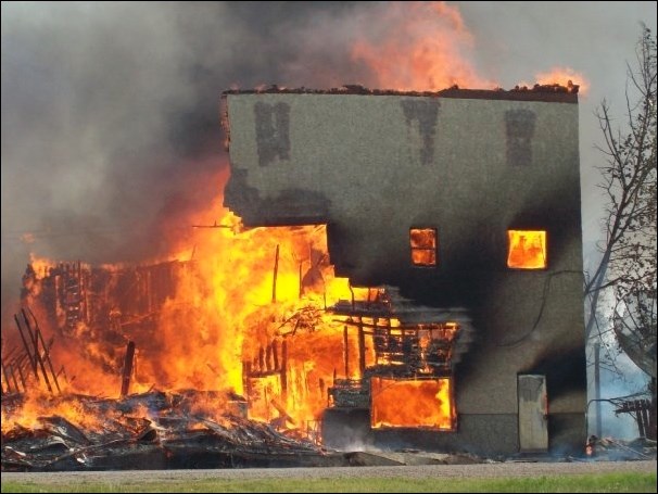 The Prelate Hotel fully engulfed in flames. Photo by Suzanne M. Howg, Facebook post