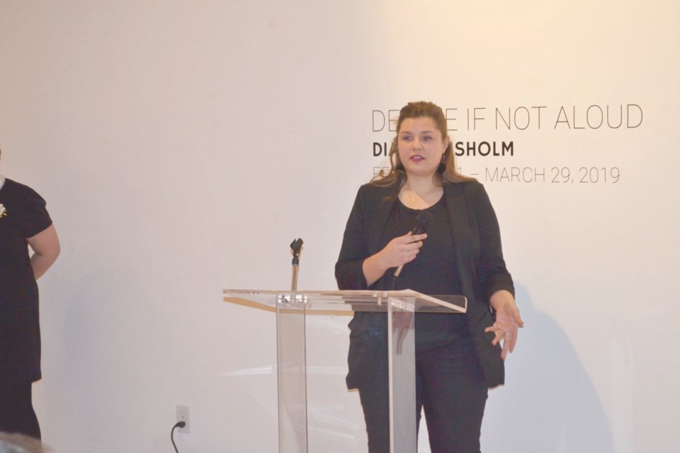 Diana Chisholm discusses her exhibit Delete if not Aloud during a reception at the Estevan Art Gallery and Museum on Friday night.