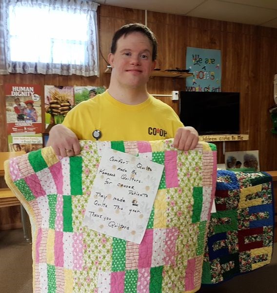 Ashly Hollett, who attended the soup and sandwich fundraiser with his family on January 30, looked at some quilts made by the Kamsack Heart and Home Quilt Club. The club made 51 quilts to be donated to cancer patients.