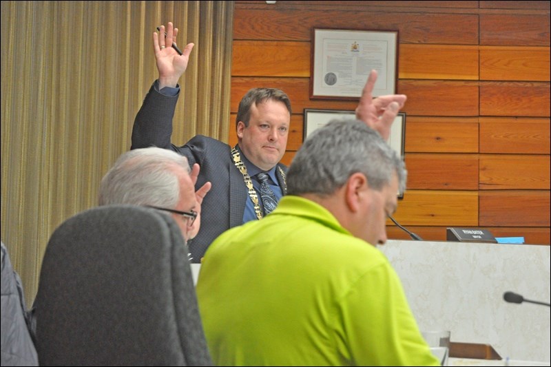Mayor Ryan Bater and members of council vote on the final approval of the North Battleford council r
