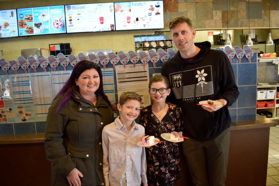 From left, Andrea, Beckham and Payton Sernick served cake along with Sash Broda from the Jim Pattison Children's Hospital Foundation of Saskatchewan on Saturday at the DQ Grill and Chill in Estevan.