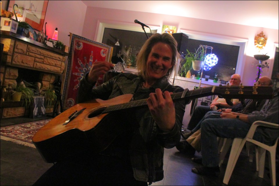 Lynne Hanson strums her guitar during the Home Routes show hosted by Ann Ross and Doug McGregor on Feb. 9. The award-winning folk musician played a pair of shows in Flin Flon during a circuit of northern Manitoba. - PHOTO BY ERIC WESTHAVER