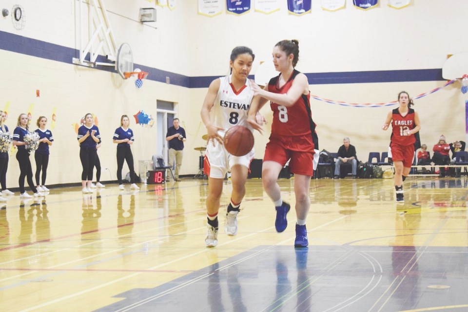 Kishi Rioferio of the Elecs tries to fend off Weyburn defender Meagan Dutchak during the senior girls basketball game.