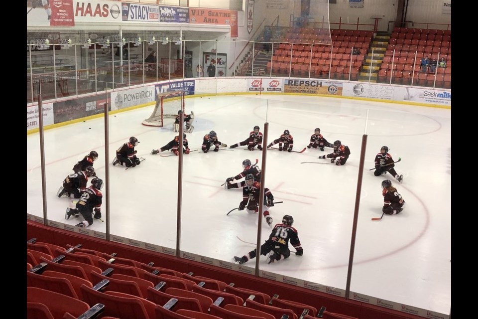 Canora Atom Cobra players were doing their warmup stretching before their final regular season game at Farrell Agencies Arena in Yorkton, a 4 to 2 win for the Cobras over the Yorkton Medicine Shoppe Terriers. From bottom left, clockwise were: Kale Strelioff, Devon Paley, Paisley Wolkowski, Linden Roebuck, Natalia Kelly, Cody Vangen (goalie), Colton Bletsky, Tucker Mydonick, Cayden Kelly, Kaelyn Shukin, Logan Sznerch, Reein Godhe, Katherine Hauber, Kayden Harder, Cooper Kraynick and Wyatt Wolkowski. Not available for the photograph was Jhett Kelly.