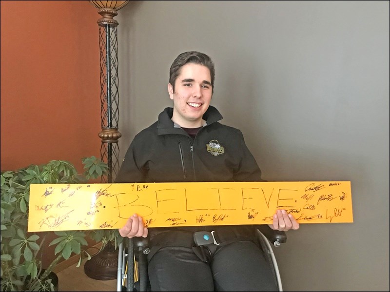 Morgan Gobeil with the “Believe” sign Humboldt Broncos Assistant Coach Chris Beaudry brought to the