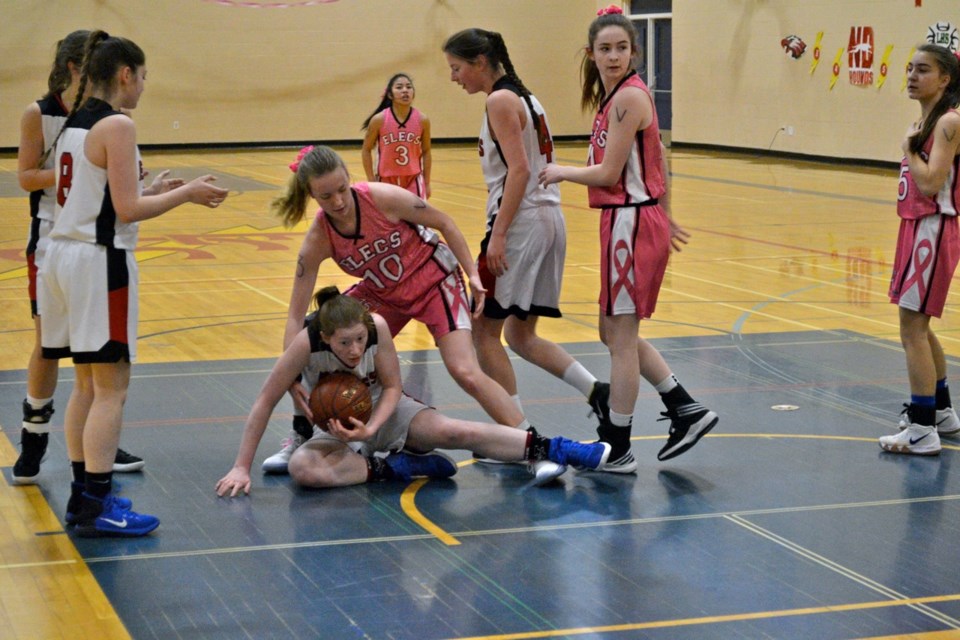 Haylee Jones (10) of the Estevan Comprehensive School Elecs senior girls basketball team tries to take the ball from a Weyburn opponent during a semifinal game at Shoot for a Cure.