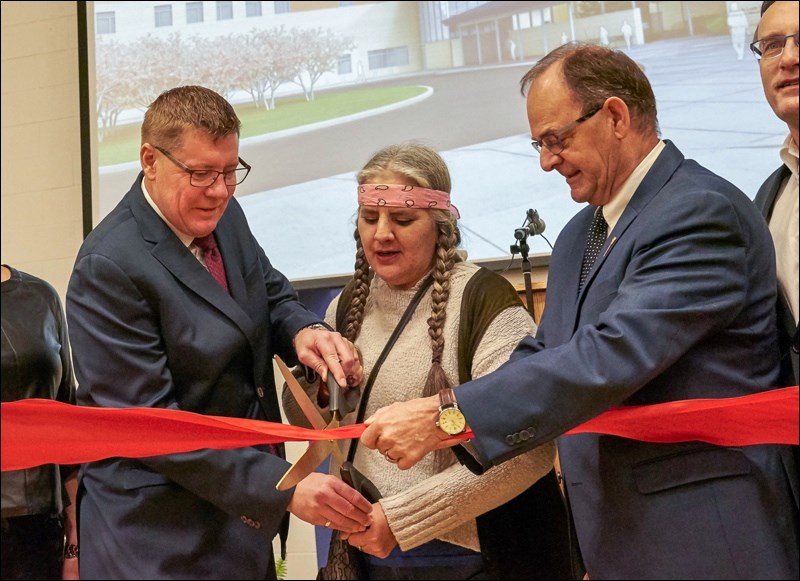 The ribbon cutting with Premier Scott Moe, Kerri L., and MLA Herb Cox.