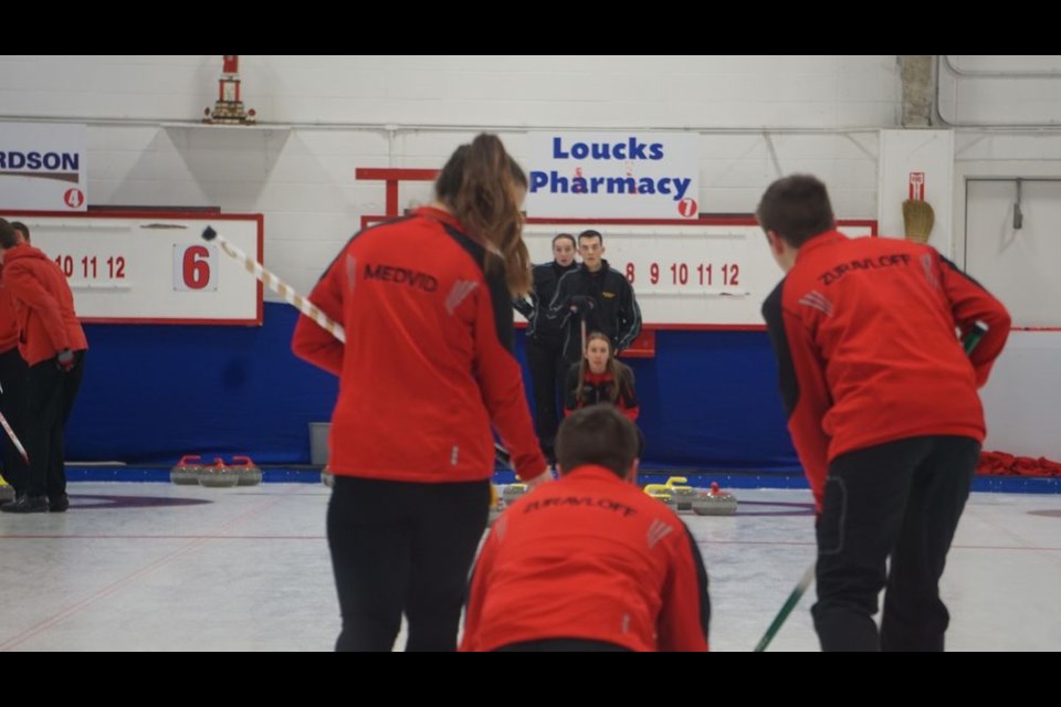 The CCS (Canora Composite School) senior mixed curling foursome competed at Curling Regionals held in Yorkton on March 1 and 2, and qualified for provincials. Brandon Zuravloff (back to camera) released a shot to sweepers Grace Medvid (left) and Lane Zuravloff (right), while Ally Sleeva (kneeling, facing camera) called the line.