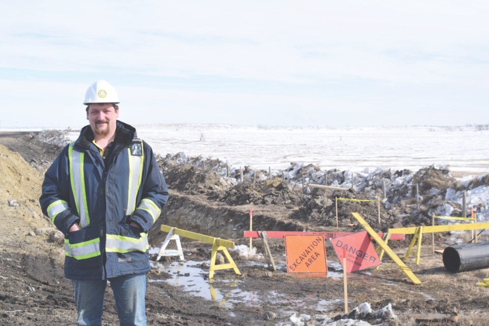 Water manager Shane Bucsis stands at the site of the pipeline construction.