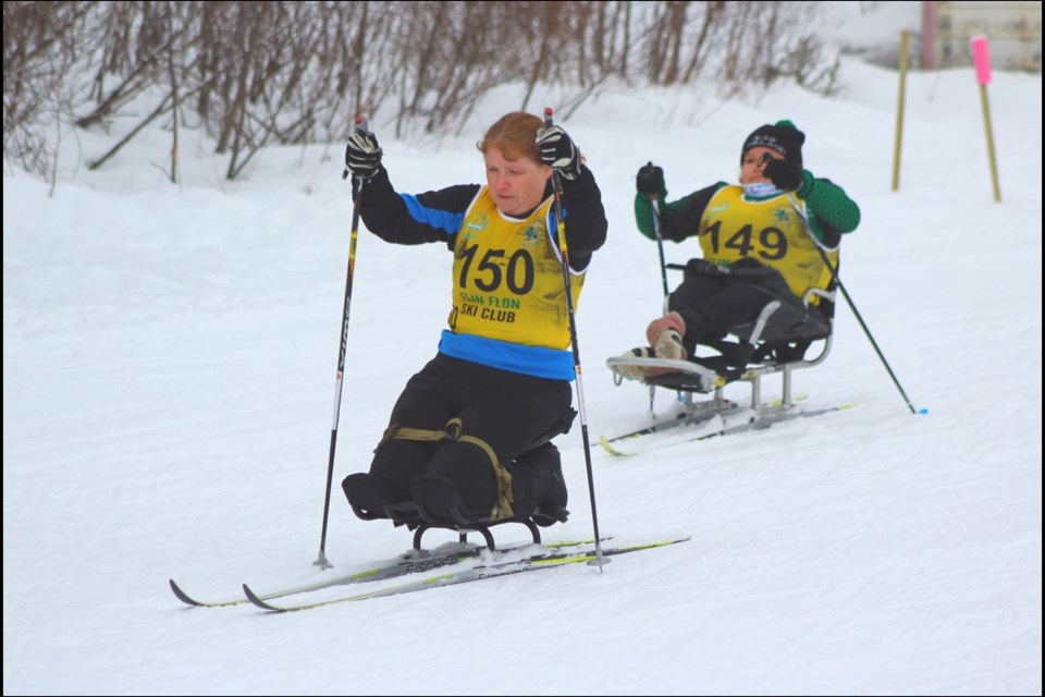 Marie Garea gets off to a strong start while Colette Bourgonje chases during the para nordic sit class ski race at the Flin Flon Ski Club March 17. The club hosted the Saskatchewan provincial cross-country skiing championships on March 16 and 17. - PHOTO BY ERIC WESTHAVER