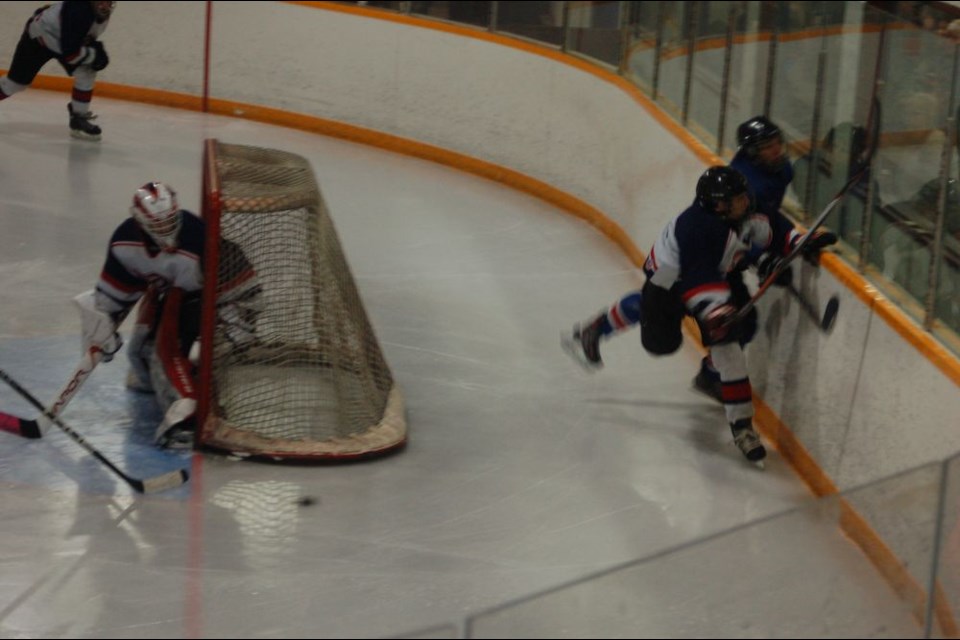 Tyler Kopec (white jersey) took on a Moosomin player in a battle along the boards.