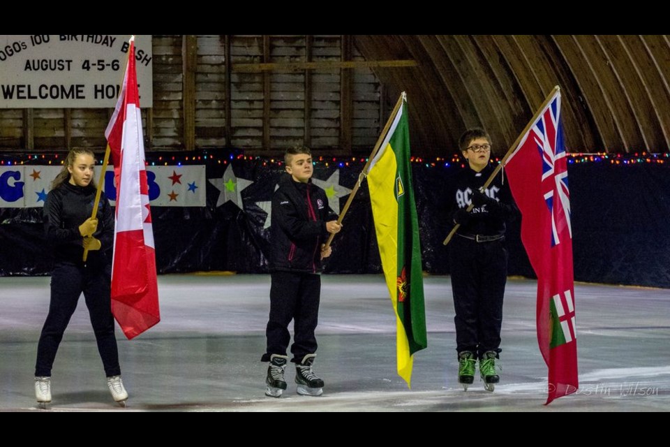 Carrying the flags during O Canada, from left, were: Kate Erhardt with the Canadian flag, Justus Blackwood with Saskatchewan and Zachary Burback with Manitoba on March 3 at the Togo Figure Skating Club’s annual ice carnival.