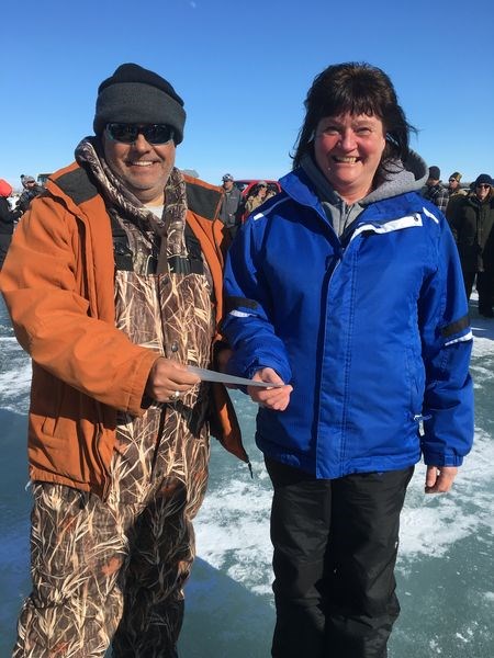 Laurie Kihn of Buchanan received her first place prize for largest walleye caught at the Buchanan Wildlife Fish Derby on March 16 from Terry Buchinski, vice-president of the Buchanan Wildlife Club.
