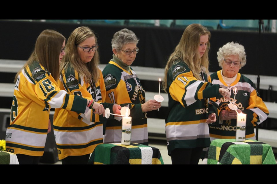 There were 29 candles at centre ice during the one-year-anniversary of the Humboldt Broncos crash at the Elgar Petersen Arena. From a central source, a flame was passed to person to person and the candles were lit. The flames were then distributed to others on the ice surface. The people on the stands used their cell phone flashlights instead. Photo by Devan C. Tasa
