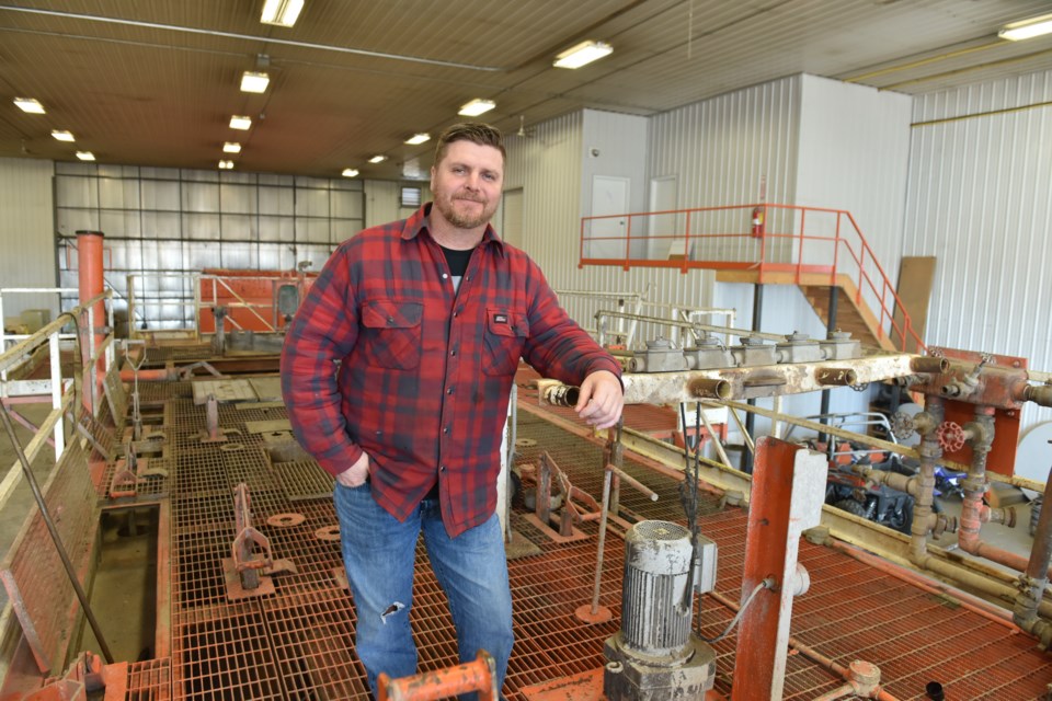 Panther Drilling’s Cory Hicks stands on a mud tank in the shop for repair on March 21. He was one of the first to post a video saying he intended to take part in the Regina Rally Against the Carbon Tax.