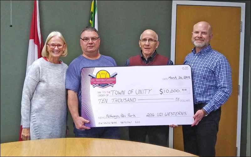 The 2016 U21 Western Canadian Softball Committee is shown presenting a portion of the proceeds from