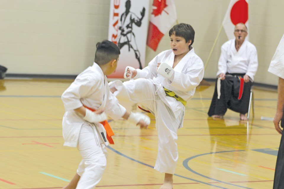 The Humboldt Karate Club hosted the provincial spring tournament at Humboldt Public School April 6.Bryce Bergerman, right, performs a kick during the kumite competition. Photo by Devan C. Tasa