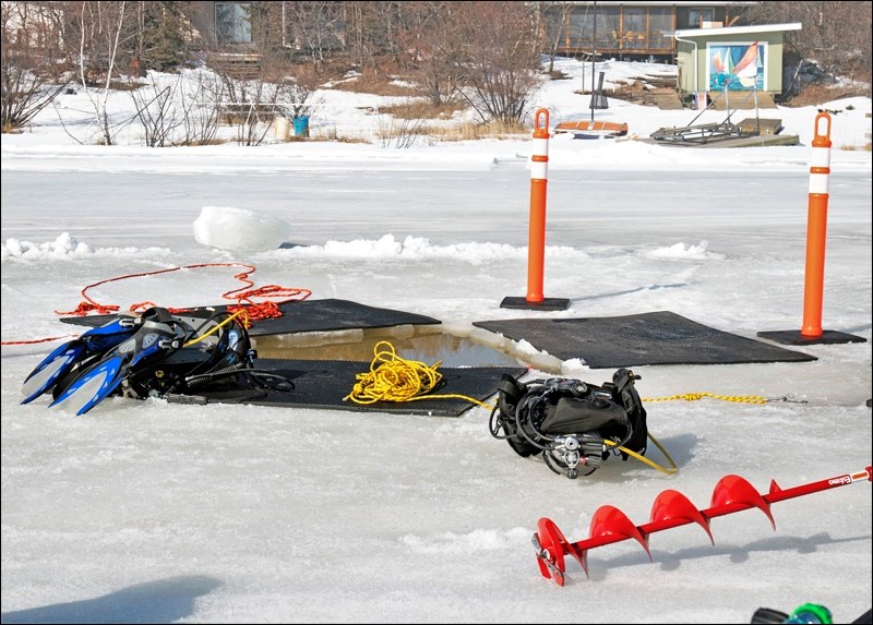 Divers make their entry into the frigid waters through a triangular hole six feet on each side. Photo by Adele Perrett