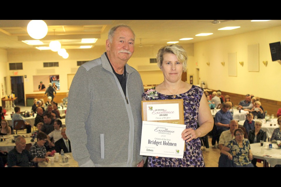 Bridget Holmen is presented with Citizen of the Year at the 4th Annual Business Excellence Awards Gala on April 10. The award was presented by Mayor Bob Gagne. Photo by Jessica R. Durling