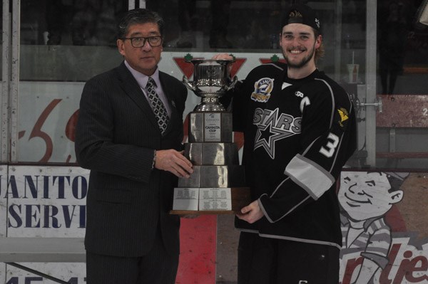North Stars captain Cody Spagrud accepts the Canalta Cup from SJHL president Bill Chow. Photo by John Cairns