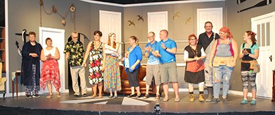 L-R: Kyle Bye, Candy Bye, Fred Perry, Bertha Isleifson, Bryanne Forcier, Denise Singleton, David Slykhuis, Monte McNaughton, Laurie Fornwald, Craig Saville, Deb Sorensen, and Wendy McNaughton get a standing ovation in The Trouble with Cats. (Photo by Mary Moffat)