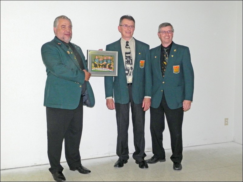 The 2016 provincial senior men’s curling team of Brad Heidt, holding the photo, with Glenn Heitt and Dan Ormsby. Missing is Mark Lang.