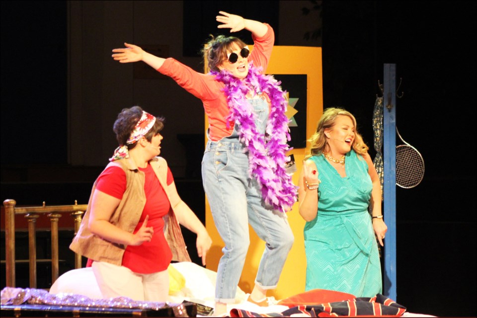 Rosie (Natalie Milligan), Donna (Emily Sparling) and Tanya (Katrina Windjack) dance and belt out a tune in Donna’s room.