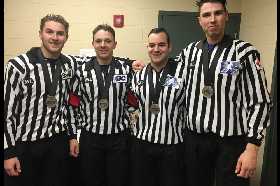 After working as linesman in the gold medal game of the World Under-17 hockey tournament, Tannum Wyonzek (far left) received a gold medal, along with the three other on-ice officials.