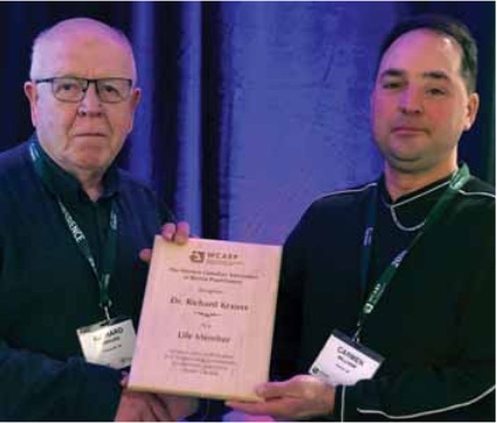 Richard Krauss, left, of Preeceville has been practicing veterinary medicine for 50 years and received a Western Canada Association of Bovine Practitioners (WCABP) - Honorary Life Membership for Outstanding Contribution.