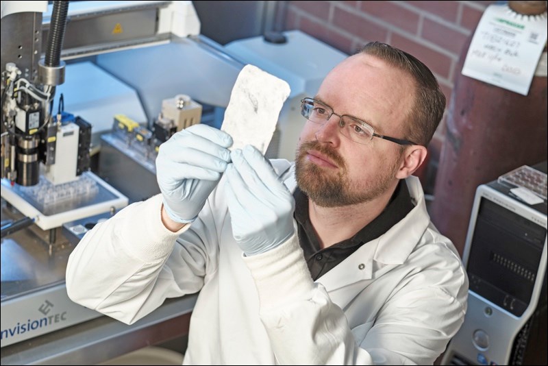 Adam McInnes 3D prints artificial tissues for growing organs one day. Photo by Dave Stobbe for Unive