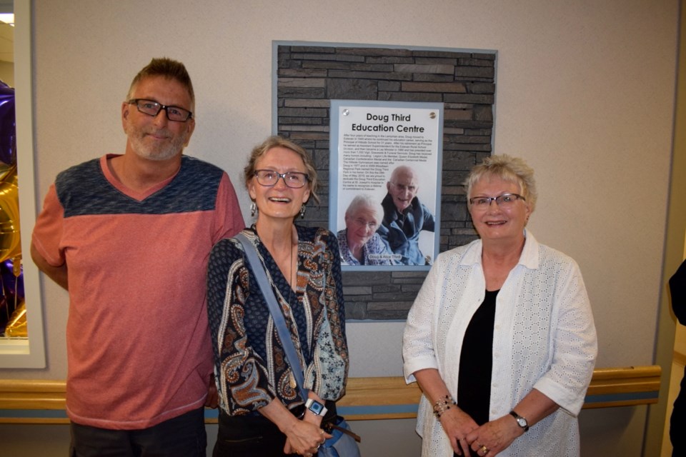 Ian Third, Margo Holinaty and Melanie Tholl flank a plaque that pays tribute to their parents Doug and Alice Third during a ceremony at St. Joseph’s Hospital on Tuesday.