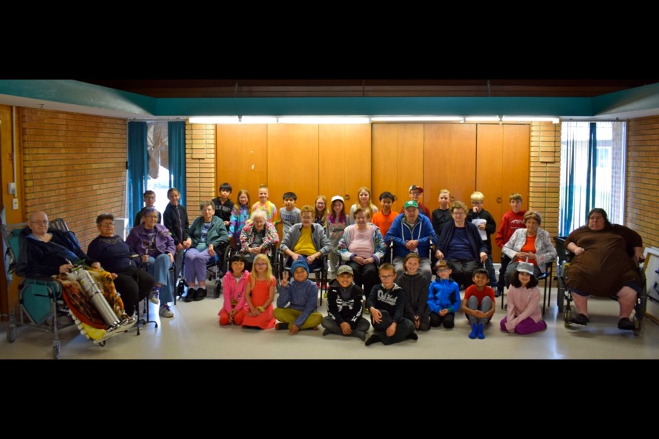 St. Mary’s Grade 4 students and their Grand Buddies gathered for a picture after an interview day together. Photo by Anastasiia Bykhovskaia