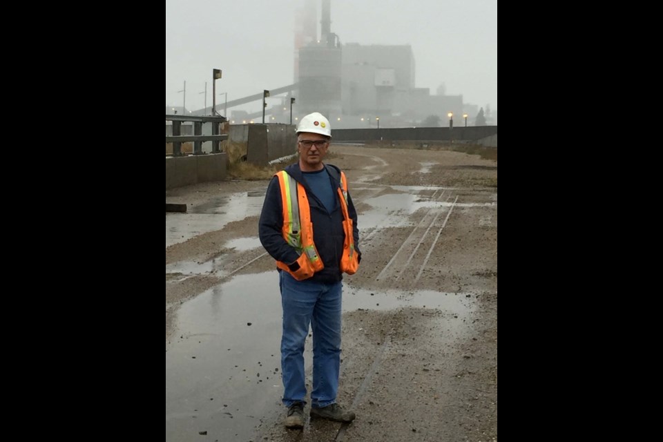 Terry Malaryk stands in front of the Shand Power Station. Photo submitted