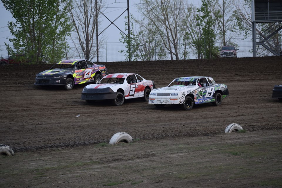 Mike Hagen (27x), Stefan Klym (5K) and Jeremy Istace (19) went three-wide in a stock car heat.