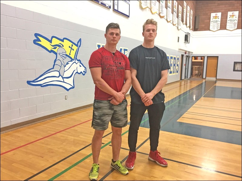 Zack Wells and Andrew Pyle with the Crusaders logo in the background. Photo by Ramona Stillar