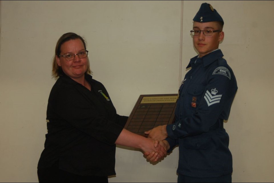 F/Sgt Eric Prestie received the best cadet of the year award during the cadet annual review ceremony. From left, were: Welma Bartel, presenter and Prestie.
