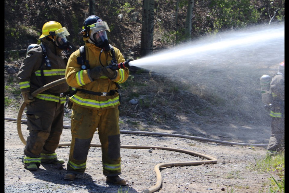 Moose Lake firefighters battle a practice fire in an abandoned garage at the end of Church Street as part of the Northern Lights Fire Academy, organized by members of the Flin Flon Fire Department. - PHOTO BY CASSIDY DANKOCHIK