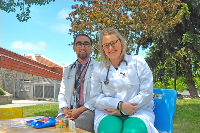 Drs. Hari Hullur and Molly Gamble report good health outcomes among local stuffed and plastic populations at the Teddy Bear Clinic, which took place in the park beside the North Battleford Public Library Friday afternoon.