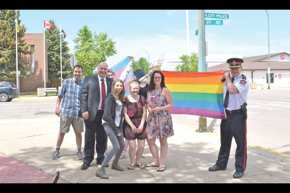 St. Paul’s United Church pastor Jason Richards, Estevan Police Chief Paul Ladouceur, Keira Weinrauch, Megan Zemlak, Gabby Bokhors, Kayla Dietzand and Deputy Police Chief Murray Cowan came for the flag ceremony at the City Hall. Photo by Anastasiia Bykhovskaia