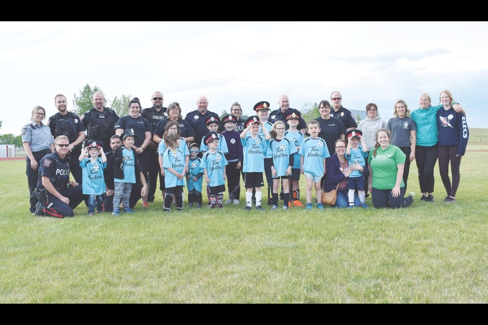 Members of the Free to Be program and the Estevan Police Service gather for a group photo before their games Tuesday night.