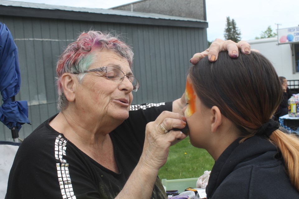 Wendy Hardcastle paints Madisyn Salisbury’s face as part of the activities during the Carrot River Family Festival on June 15. Photo by Jessica R. Durling