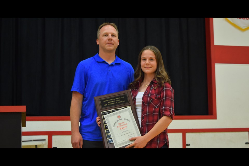 Chad Hofmann presents Abbie Korte with the Lenz-Weber award for athletic and academic achievement at the Muenster School year-end awards on June 19. Photo by Kiernan Green