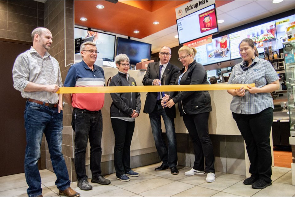 From left, restaurant manager John Jenish, owner-operator Tim Jenish and Chris Jenish, Mayor Roy Ludwig, MLA Lori Carr and first assistant Cherry Boloto. Photo by Robert Godfrey.