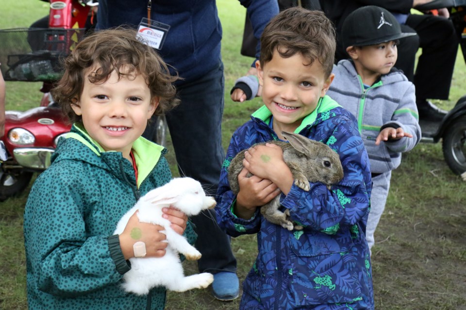 Lincoln and Kaiden Kruger hold bunnies at the Hope Outreach Humboldt family fun event at St. Elizabeth Park on June 22. Photo by Devan C. Tasa