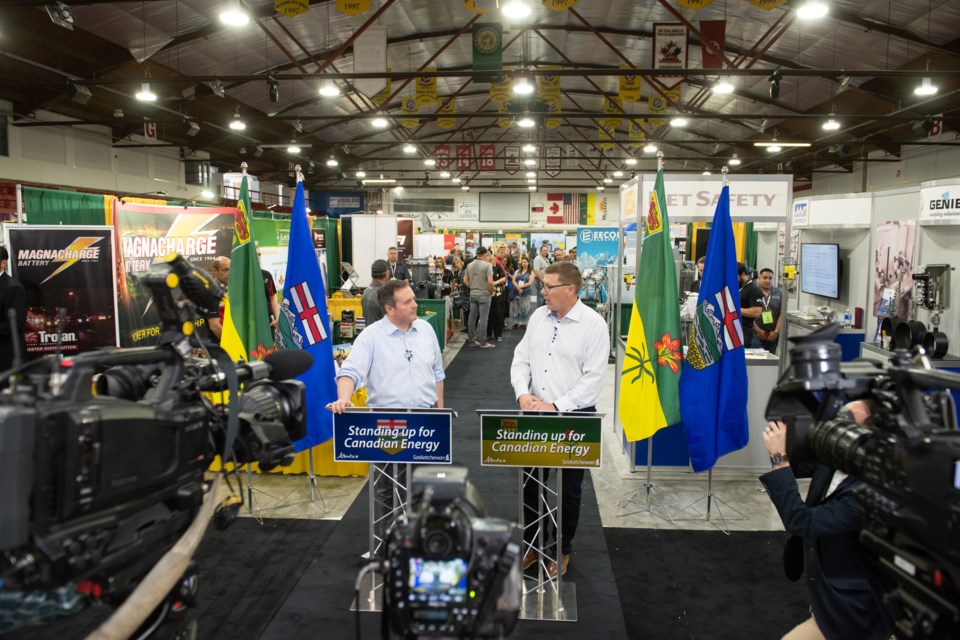 Alberta Premier Jason Kenney, left, and Saskatchewan Premier Scott Moe took questions from the media on the floor of the oil show.