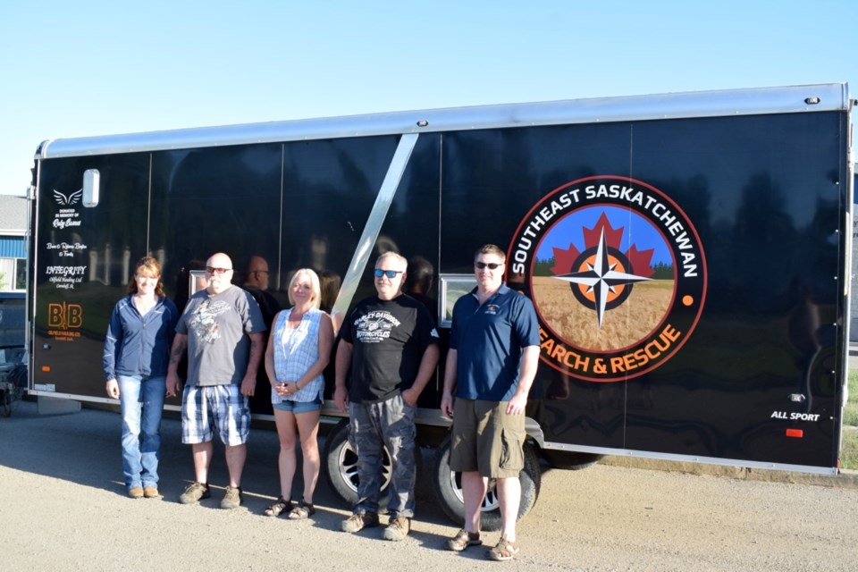 From left, Southeast Saskatchewan Search and Rescue president Katia Bigney, Bruce, Rebecca and Jeff Bayliss, and search and rescue vice-president Dan Hardern participate in the donation of an incident command trailer on Wednesday night. The Bayliss family made the donation in memory of Ruby Barnes.
