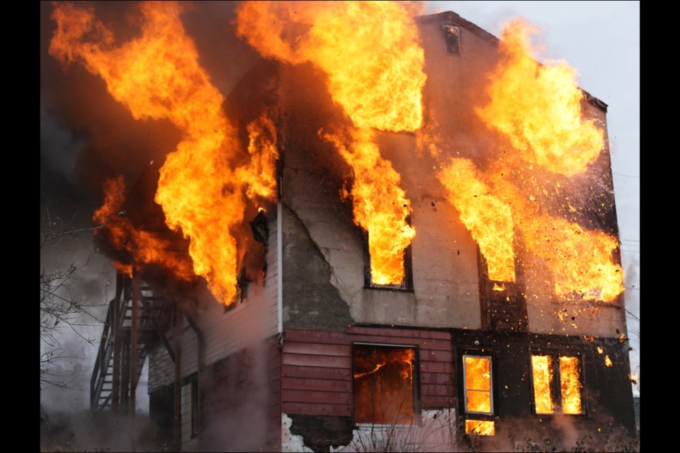 A vacant building on Island Drive is engulfed in flames during a training session for Flin Flon Fire Department members last fall. - PHOTO BY DANIEL DILLON