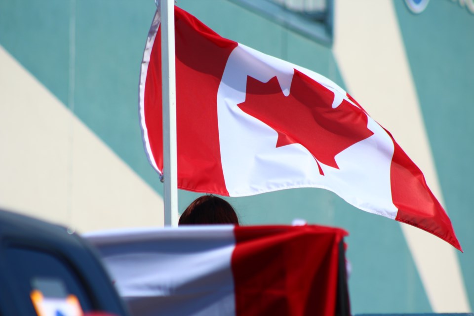 A Canadian flag waves in the breeze on Green Street.