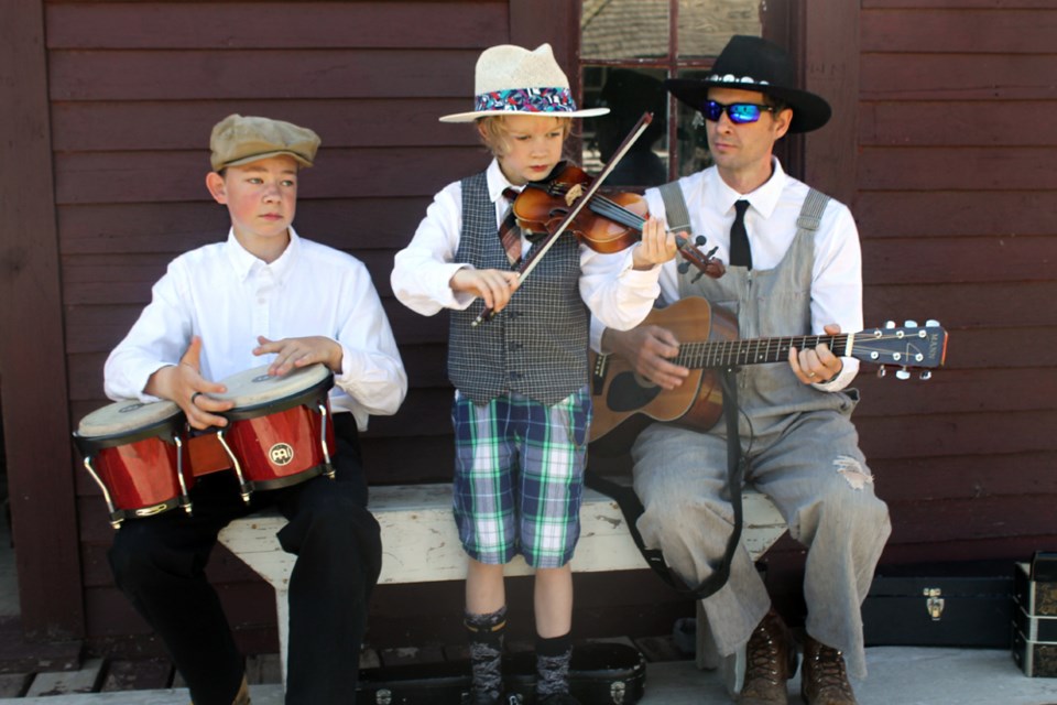 From left, Ronny Browning, Timothy Browning and Ron Browning busking at the Tisdale and District Museum's Doghide Village for the Canada Day festivities. The museum had the old fashioned village running and operational for the day, to give a look into Canada’s past. Photo by Jessica R. Durling